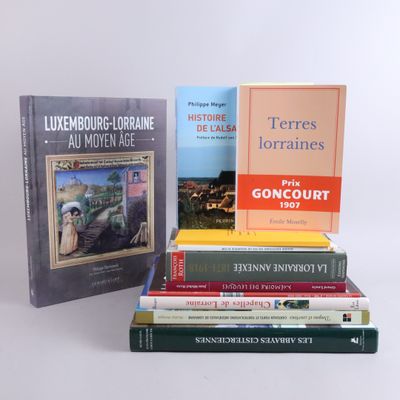 several books are stacked on top of each other on a table