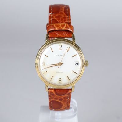 a close up of a wrist watch on a stand