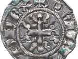 une vieille pièce d'argent ornée d'une croix