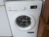 an image of a washing machine and a microwave in a room
