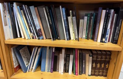 a book shelf with many books on it in a library