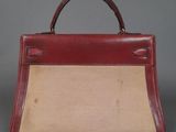 an image of a red and beige purse with a handle