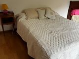 a bed with a white bedspread and pillows on it