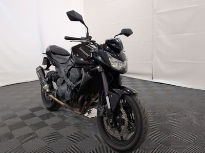 a black motorcycle that is parked in a room