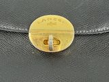 black leather purse with a gold clasp on it