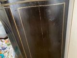 a black cabinet in the corner of a room
