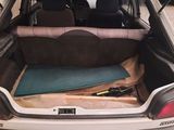 the back of a car with a bed in the trunk of it