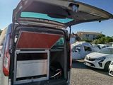 cars parked in a lot with open doors in the sun