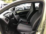 the interior of a small car with black seats and a steering wheel