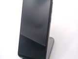 a cell phone that is sitting on top of a stand