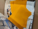 a box full of yellow envelopes sitting on top of a table