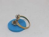 an image of a gold and diamond ring on a blue sponge