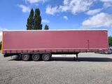 a red semi trailer parked in a parking lot