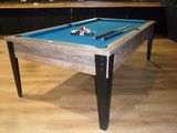 a pool table with a blue cloth on it in a room