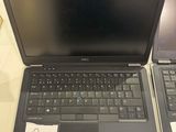 two laptops that are sitting side by side on a table