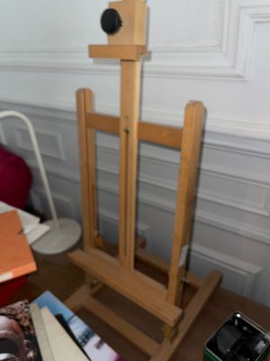 une photo d'un chevalet en bois sur lequel est posé un livre
