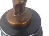 bronze statue of a man holding a tennis racquet on a black base
