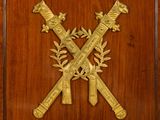 an image of a wooden plaque with two crossed swords on it