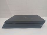 a black laptop sitting on top of a white table