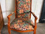 an old wooden chair with a floral upholstered seat
