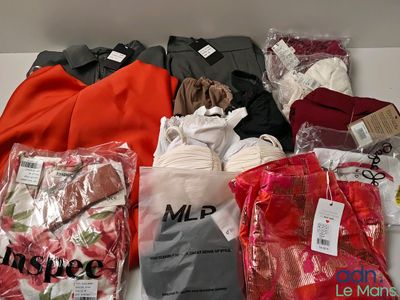 many different types of clothing on the table together