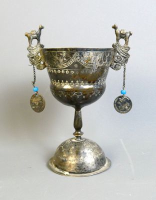 a silver cup that is sitting on top of a table