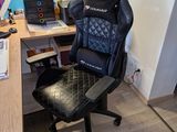 a desk with a chair and a computer on it