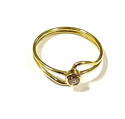 yellow gold ring with a single diamond on a white background