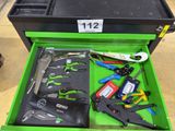 a green tool box with tools in it on the floor