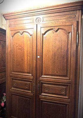 an image of a large wooden armoire in a room