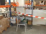 a chair and a table in a room with shelves