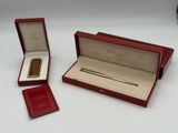 a red box with a gold pen and a red box with a gold pen and a red box with a gold pen and a red box with a gold