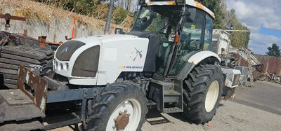 a tractor that is parked on the side of the road