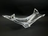 clear glass bowl on a black surface with a black background