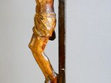 a statue of a man hanging from a cross on a pole