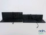 two keyboards that are sitting on a white table