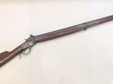 a rifle that is on display in a glass case