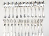 a lot of silver spoons and forks on the table