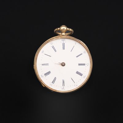 an antique gold pocket watch with roman numerals on the face