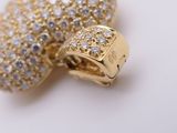 a gold and white diamond ring on a white surface