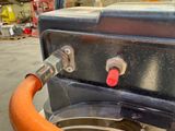 a close up of an orange hose attached to a machine