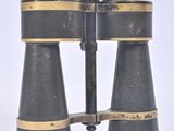 an old pair of binoculars sitting on top of a white surface