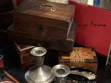 a display case filled with silver items on a table