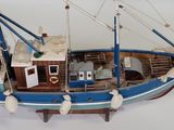 a model of a boat on display on a white surface