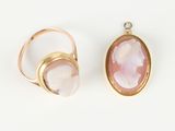two gold rings with a pink stone in the middle and a white stone in the middle