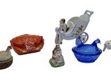 several figurines of different sizes and shapes are displayed on a white surface