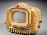 a small television sitting on top of a wooden box