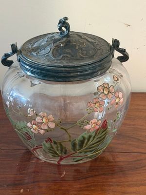 a glass jar with a lid sitting on a wooden table