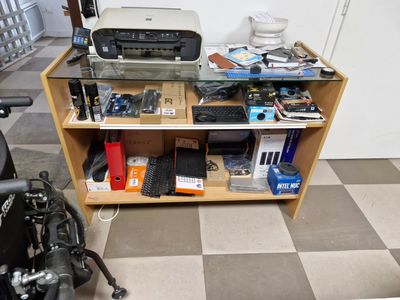 a bike parked in front of a desk with a printer on top of it