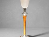 a close up of a lamp on a wooden base with a white glass shade